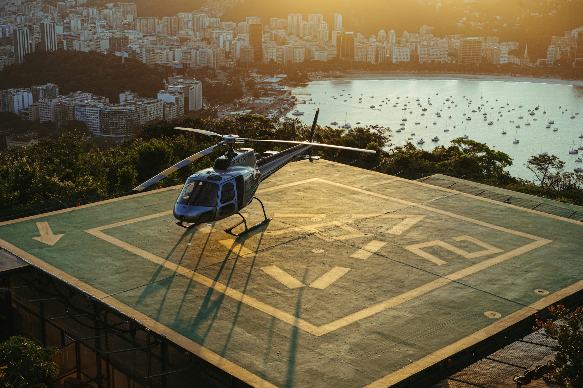 A helicopter on a waterside helipad
